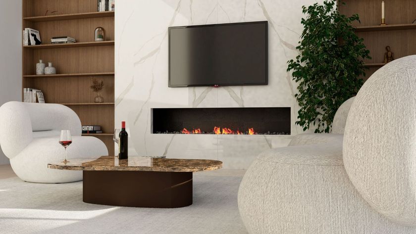 A contemporary living room with a marble effect feature wall and a wall mounted television above a modern fireplace 