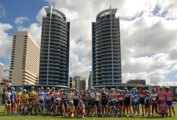 The men's and women's peloton pose for a photo.