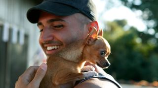 Owner carrying chihuahua on his shoulder