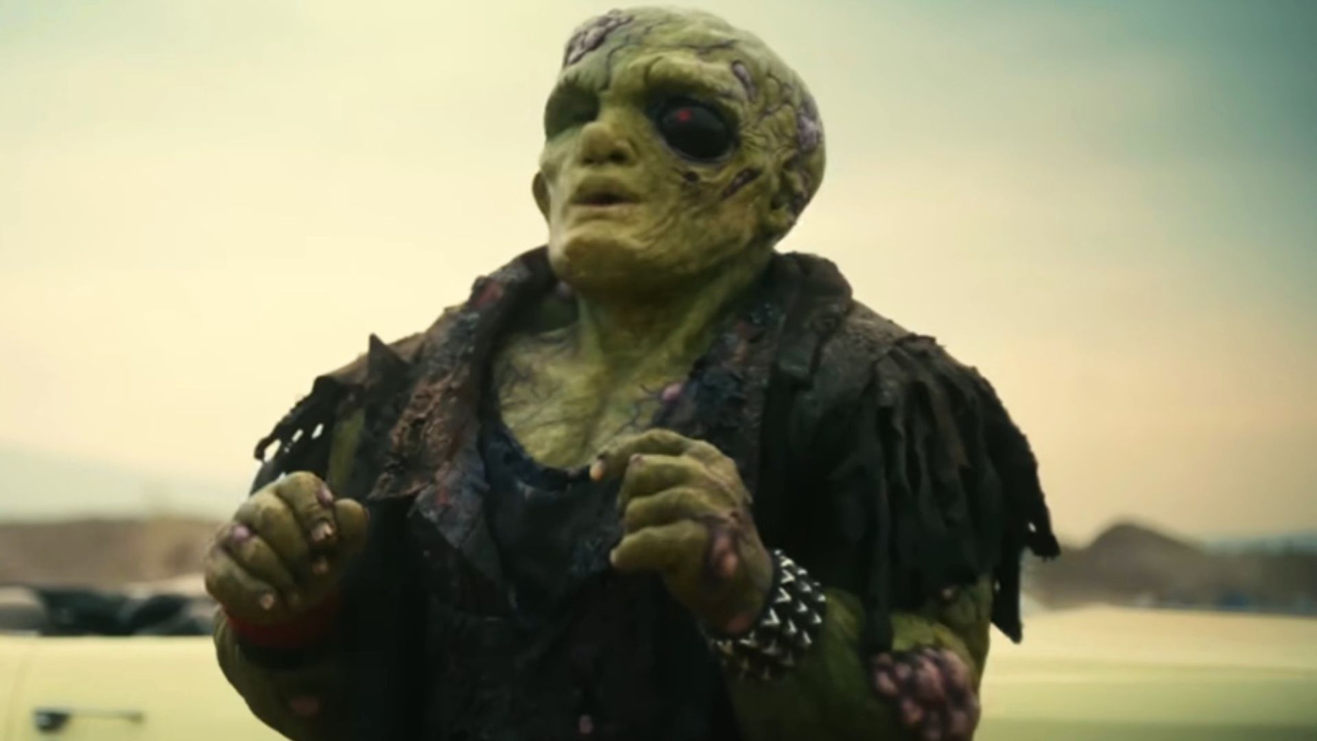 Peter Dinklage with his hands raised in The Toxic Avenger