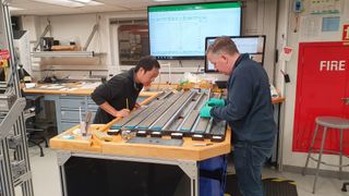 Scientists examine sediment cores drilled up from the seabed in Santorini aboard the research ship.