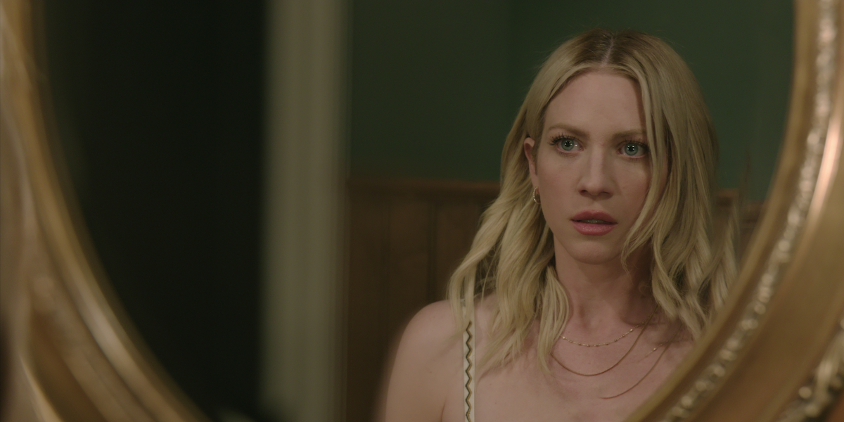 brittany snow as sophie looking in the mirror shocked in the hunting wives