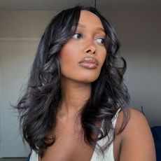 Image of Mona Ali with a blowout hairstyle.