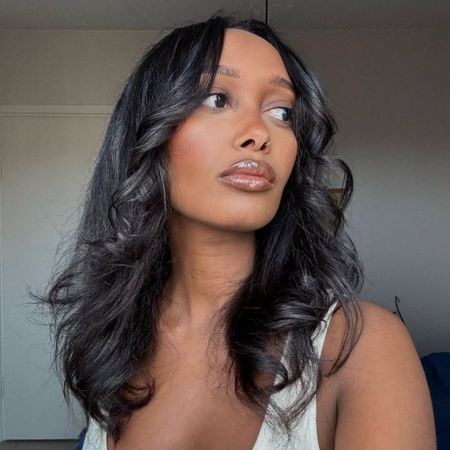 Image of Mona Ali with a blowout hairstyle.