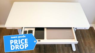 The FlexiSpot Comhar standing desk with a Price Drop badge