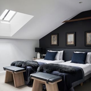 Navy bedroom with white ceiling and twin beds