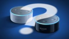 Amazon Echo Dot in black and white with a question mark cast onto them in light