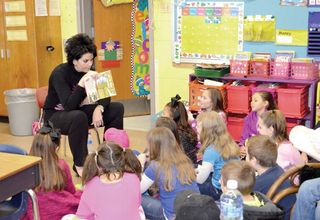 Jenny Lynn Hatter, Chief Academic Officer of Harrison County Schools, reading to elementary students.