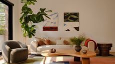 living room with curved coffee table and bright rug
