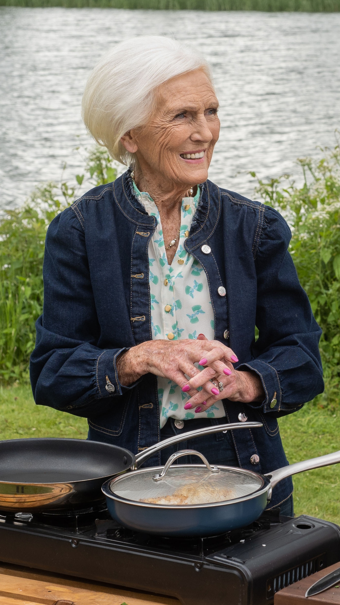 Dame Mary Berry smiles, as she cooks outside on Mary at 90