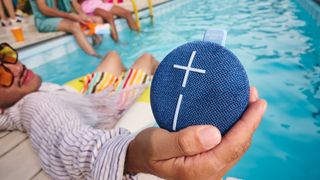 Ultimate Ears Miniroll held in a pool