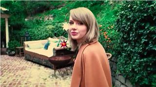 taylor swift in garden area and couch