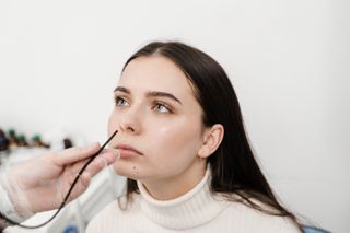 Endoscope about to go up woman's nose