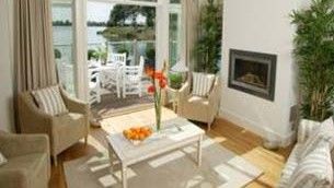 eco home with white wall and arm chair with flower vase on table