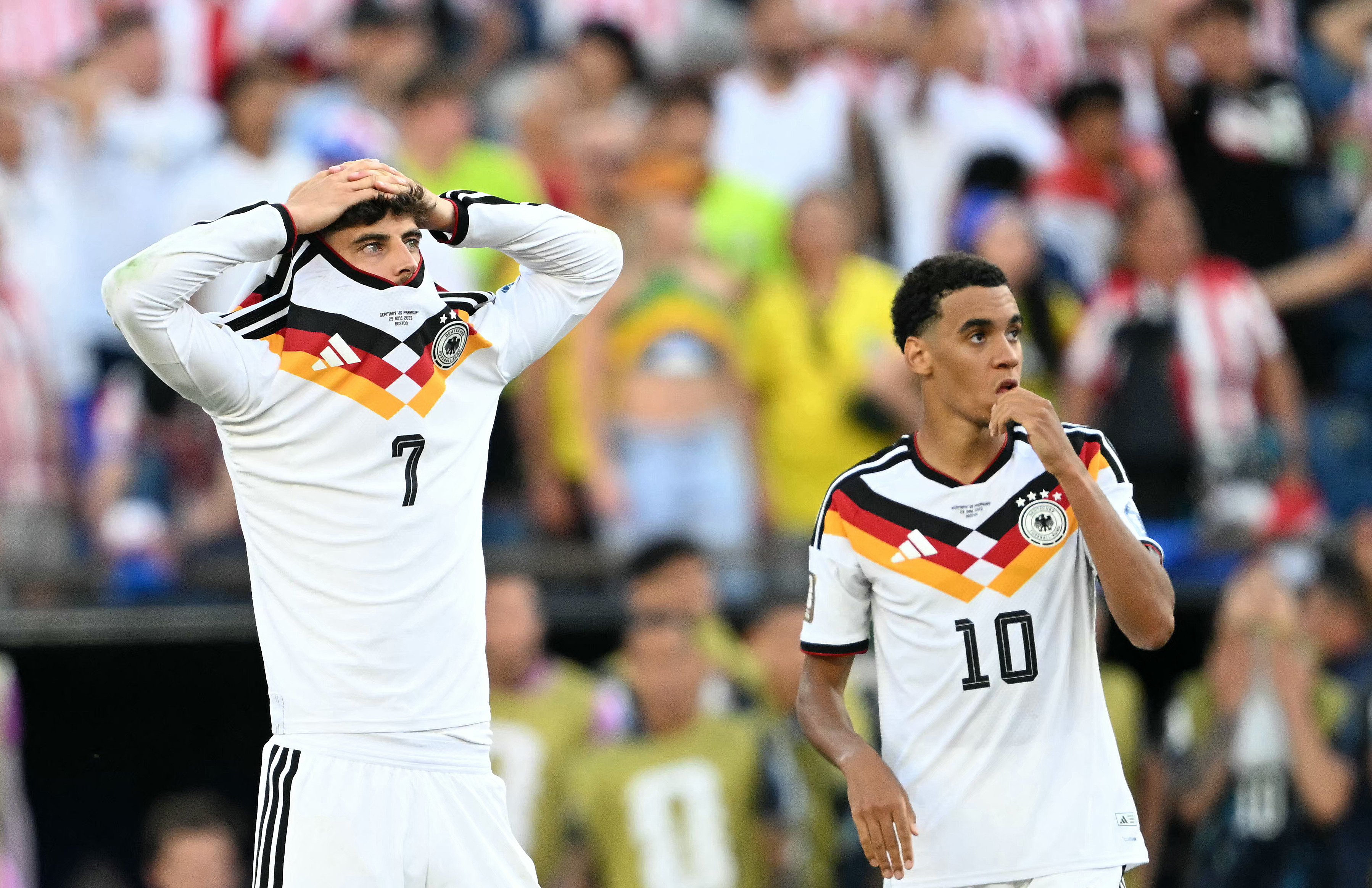 Germany stars Kai Havertz and Jamal Musiala react after losing the penalty shootout against Paraguay