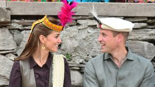 Kate Middleton and Prince William smile at each other during a visit to the settlement of the Kalash people, to learn more about their culture and unique heritage, on October 16, 2019 in Chitral, Pakistan.