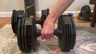 Person exercising with the NordicTrack Select-A-Weight Dumbbell Set