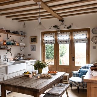kitchen with christmas touches and farmhouse table and french windows