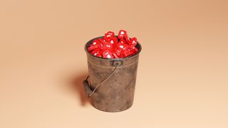 Metal bucket full of red numbers on beige background