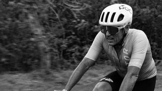 A black and white image of Factor Bikes' CEO Rob Gitelis riding a bike