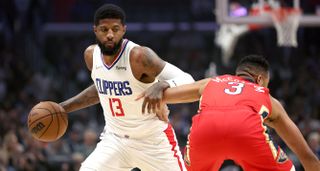 Paul George No. 3 of the LA Clippers dribbles past CJ McCollum No. 3 of the New Orleans Pelicans during the first half of a game at Crypto.com Arena on April 03, 2022 in Los Angeles, California.