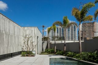 AG House by camila porto, a low brazilian house made of wood and exposed concrete