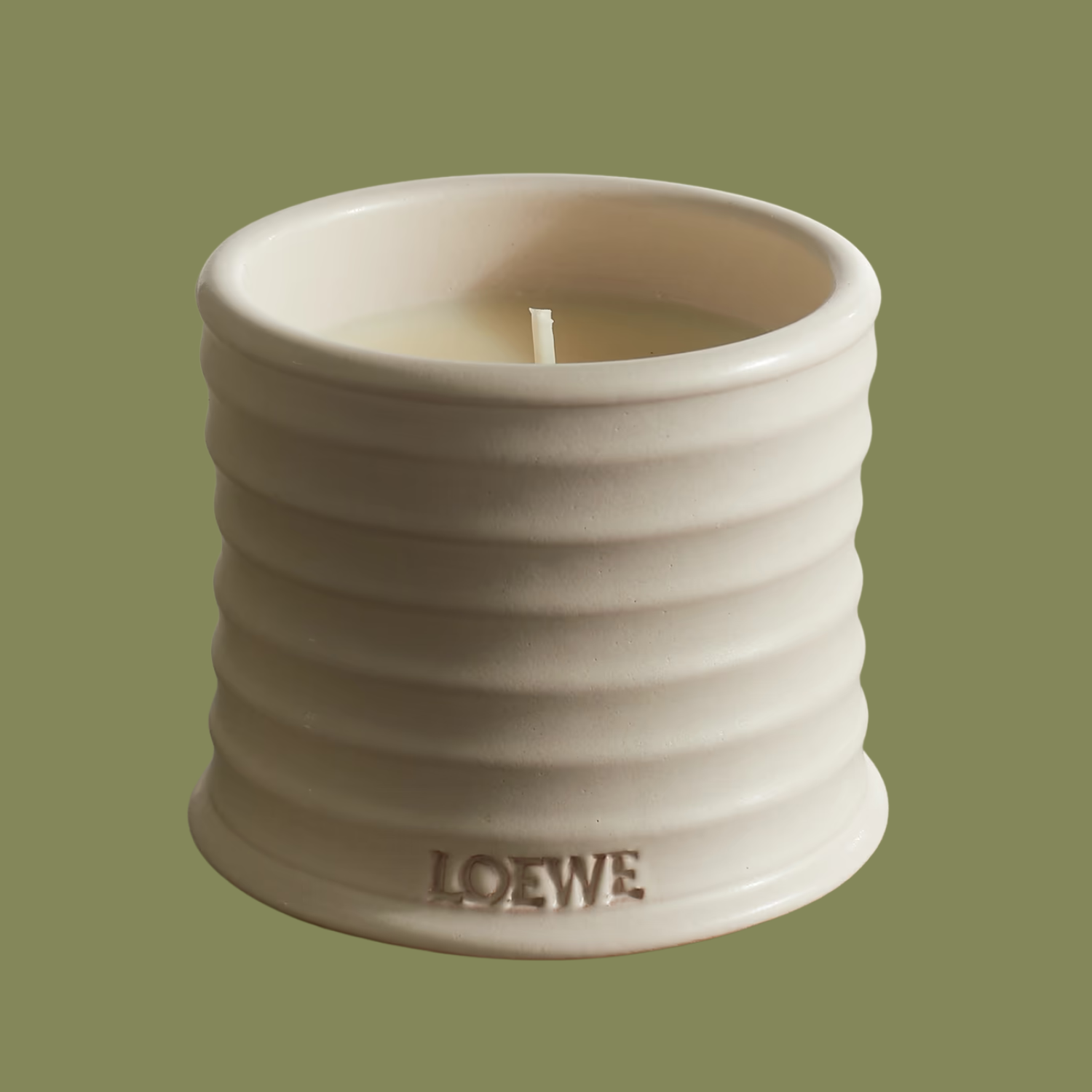 A ridged white ceramic candle