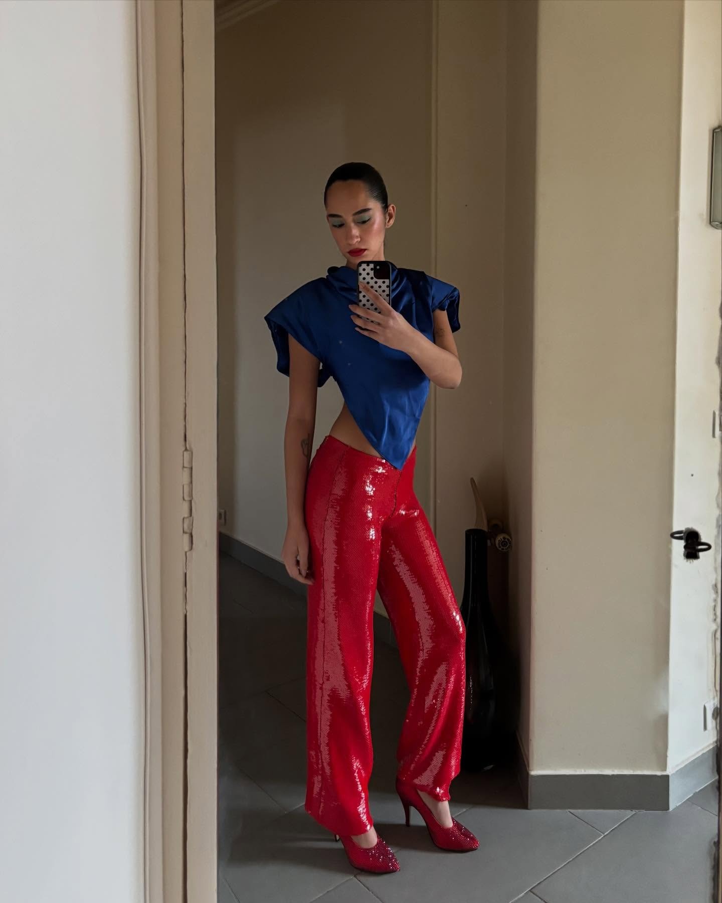 Emna wearing a blue and red outfit.