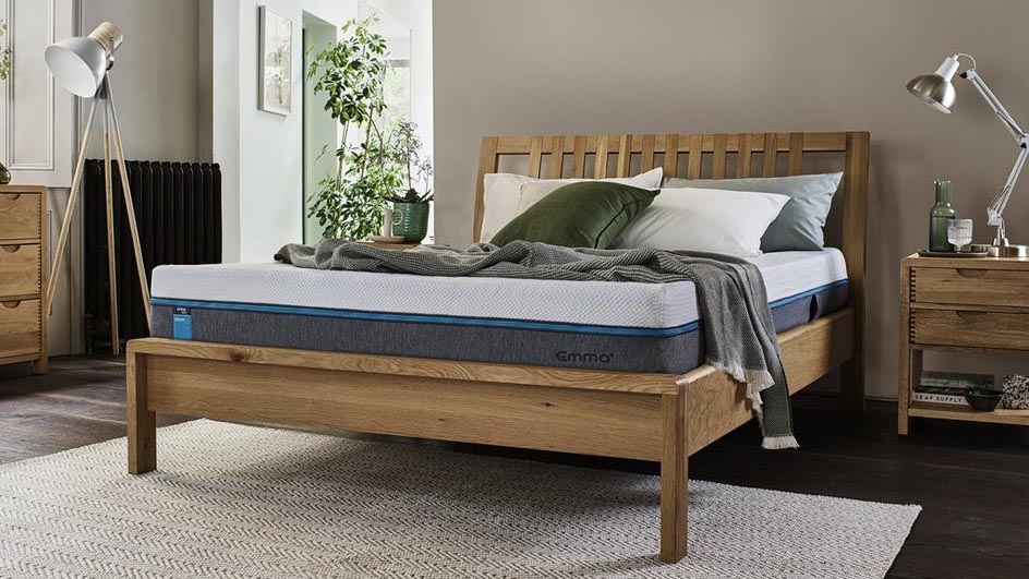 The Emma Select Helix Firm mattress shown on a light wood bed frame