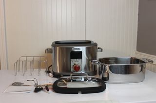 The Wolf Gourmet Multi-Function Cooker out of the box next to all the accessories