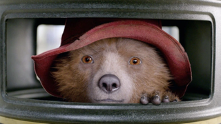 paddington bear peers out of a trash can in Paddington 2 (2017)