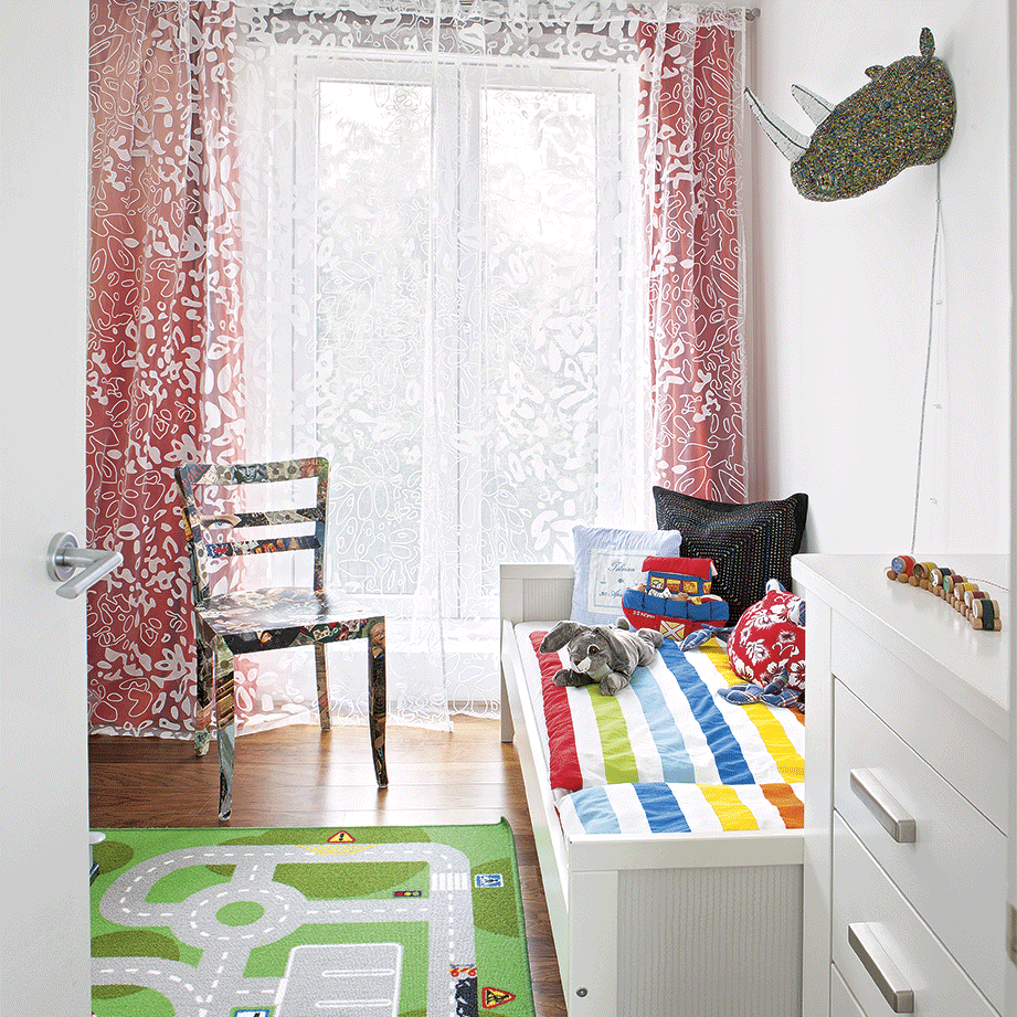 childrens room with play mat clothing and toy storage