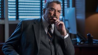 Tom Selleck sits pensively in his dark office in Blue Bloods S14 E18 - "End Of Tour."