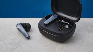 A pair of EarFun Air Pro 3 wireless earbuds – one earbud sitting in the case and the other sitting outside