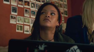Rihanna sitting by a laptop in Ocean's Eight.