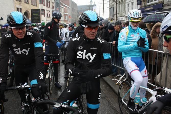 Chris Sutton (Team Sky) tries to keep warm on the start line