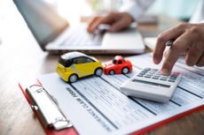 Toy cars on top of car finance form