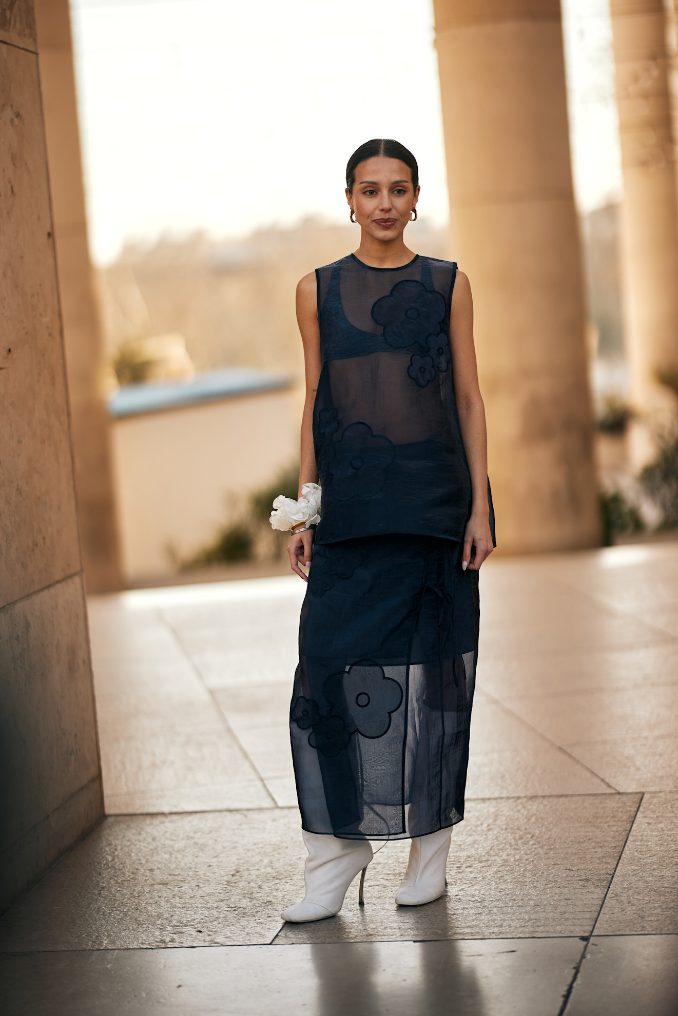 woman wearing white boots navy sheer dress