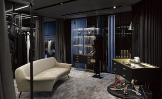 Divided into zones, the boutique is dominated by dark wooden cabinetry and shelving