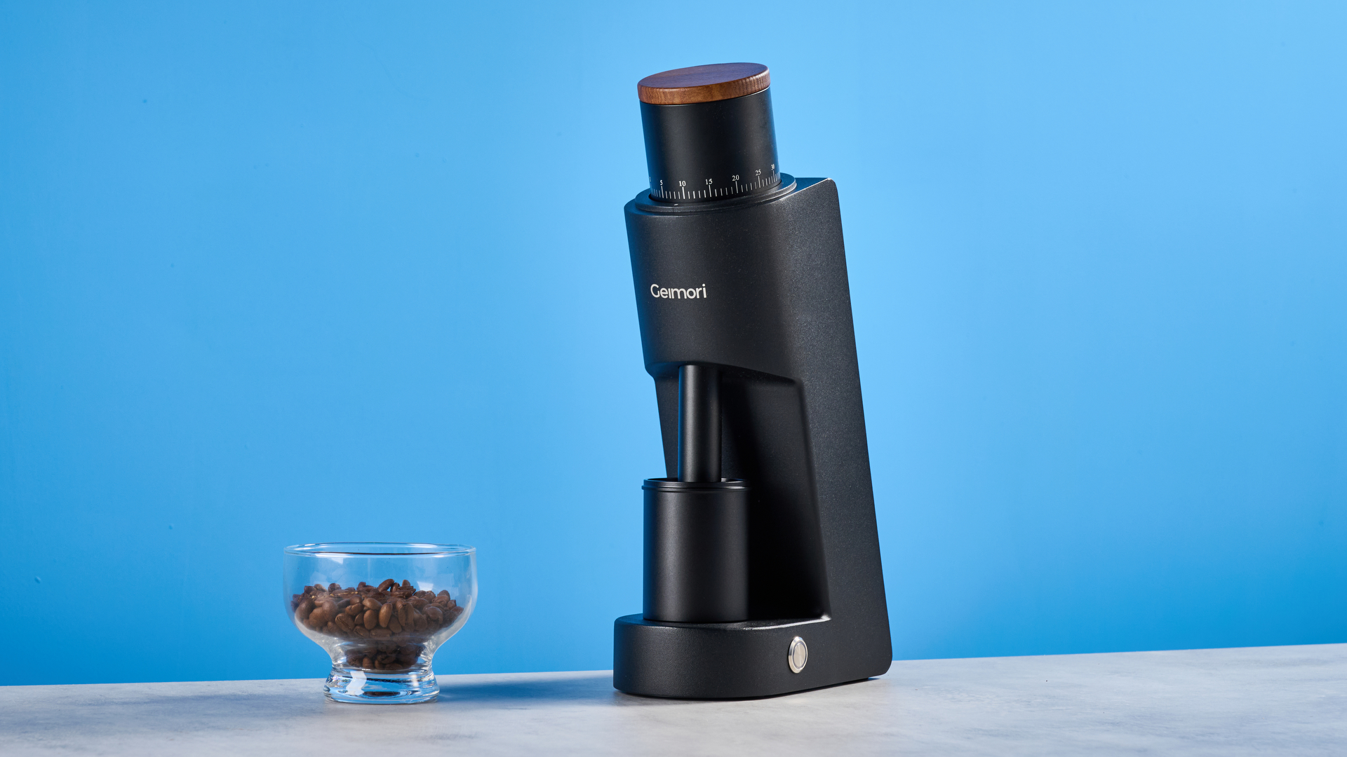 the wirsh geimori gu38 coffee grinder in black with a walnut hopper lid photographed against the blue tom's guide background