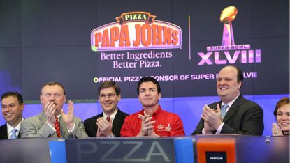 John H. Schnatter, Founder, Chairman & CEO of Papa John's International, Inc. (C), with David Wicks of Nasdaq (2nd R) and rep