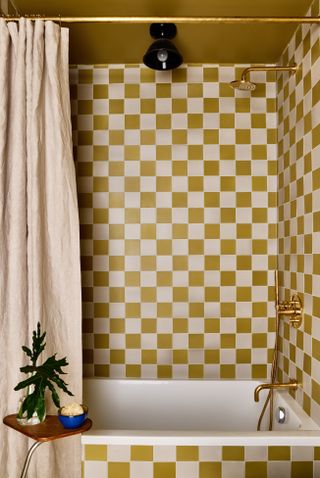 Bold yellow and white checked tiles in a small bathroom