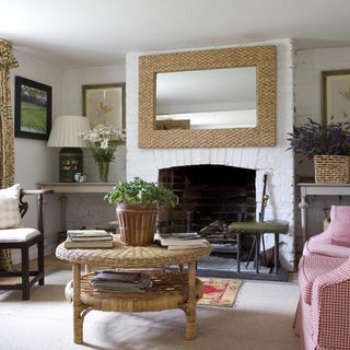 living room with weave mirror and console table