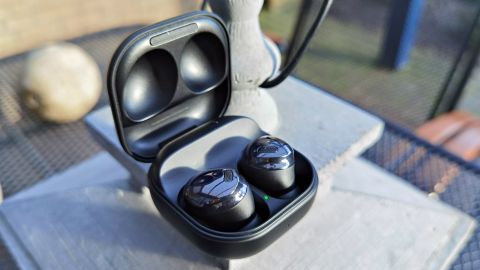 The Samsung Galaxy Buds Pro pictured in their charging case laying on a table