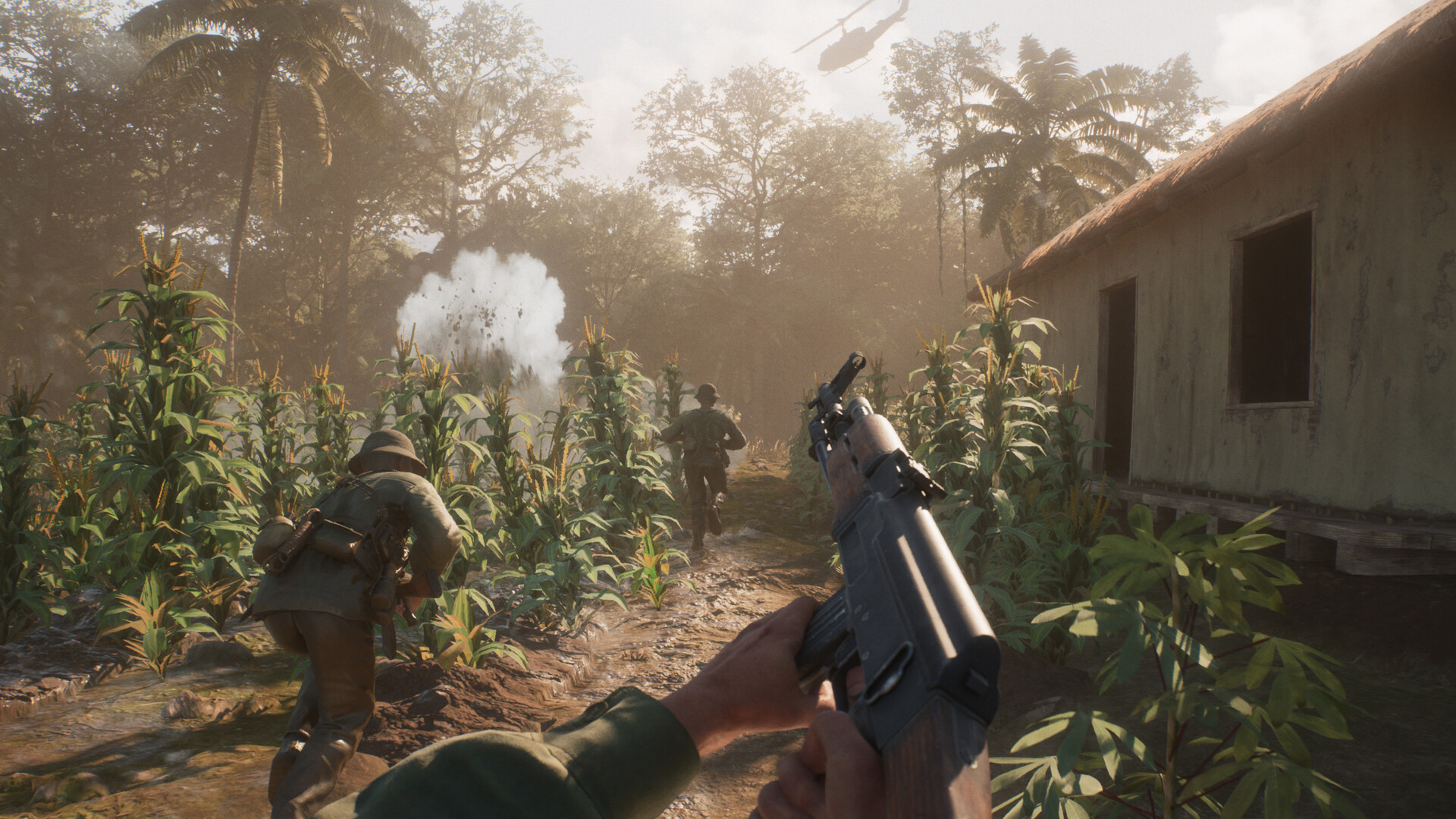 Hell Let Loose: Vietnam screenshot of soldiers charging through crops as an explosive sets off in the distance