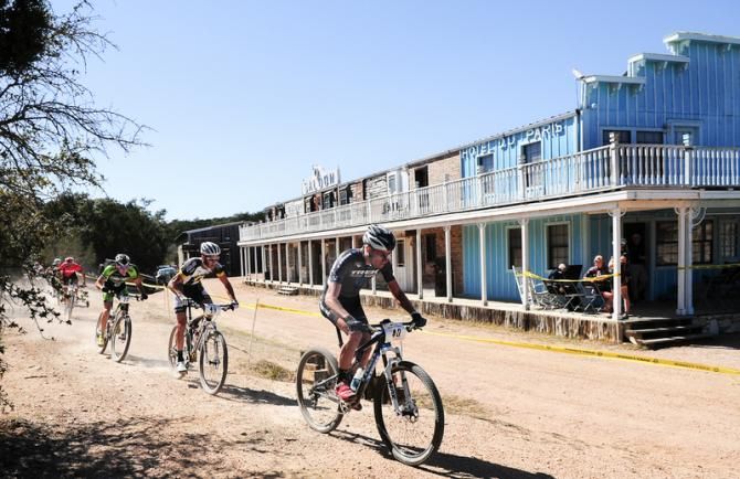 Daniel McConnell (Trek Factory Racing) leading past an old western village on lap one