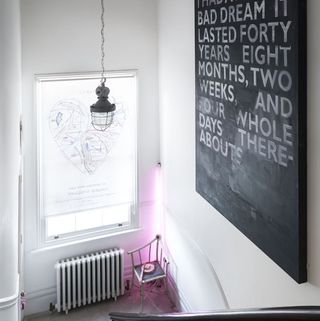 stair case with whindow and blackboard