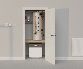 ground source heat pump in cupboard with water cylinder above