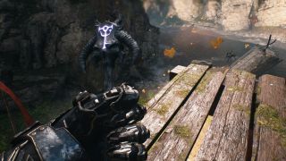 Doom: The Dark Ages purple key Siege Part 1 - A first-person image of Doom Guy holding the demonic purple key in his left hand.