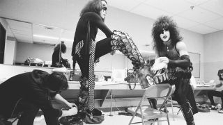 Gene and Paul clown for the camera as Gene gets his massive boots on during the Rock & Roll Over tour, 1977